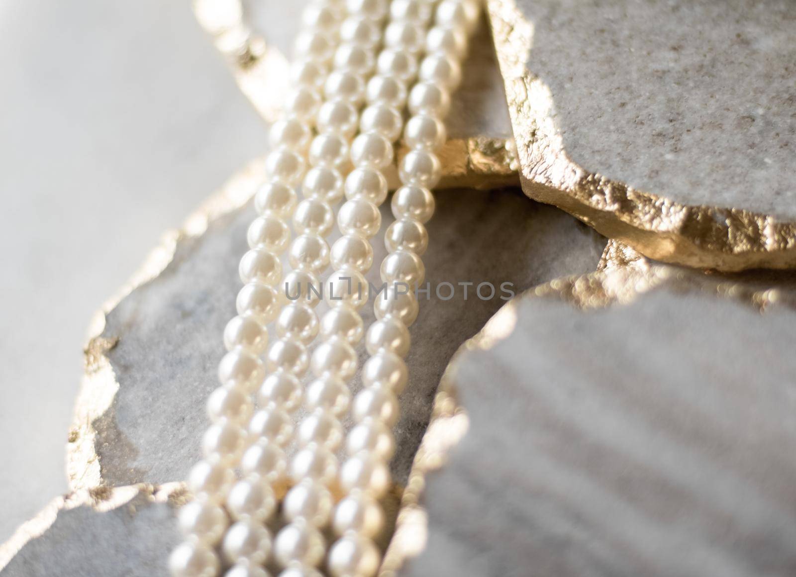 Pearl necklace on golden marble, ethical jewellery - luxury background, jewelry as a gift concept. Pearls are girl's best friends