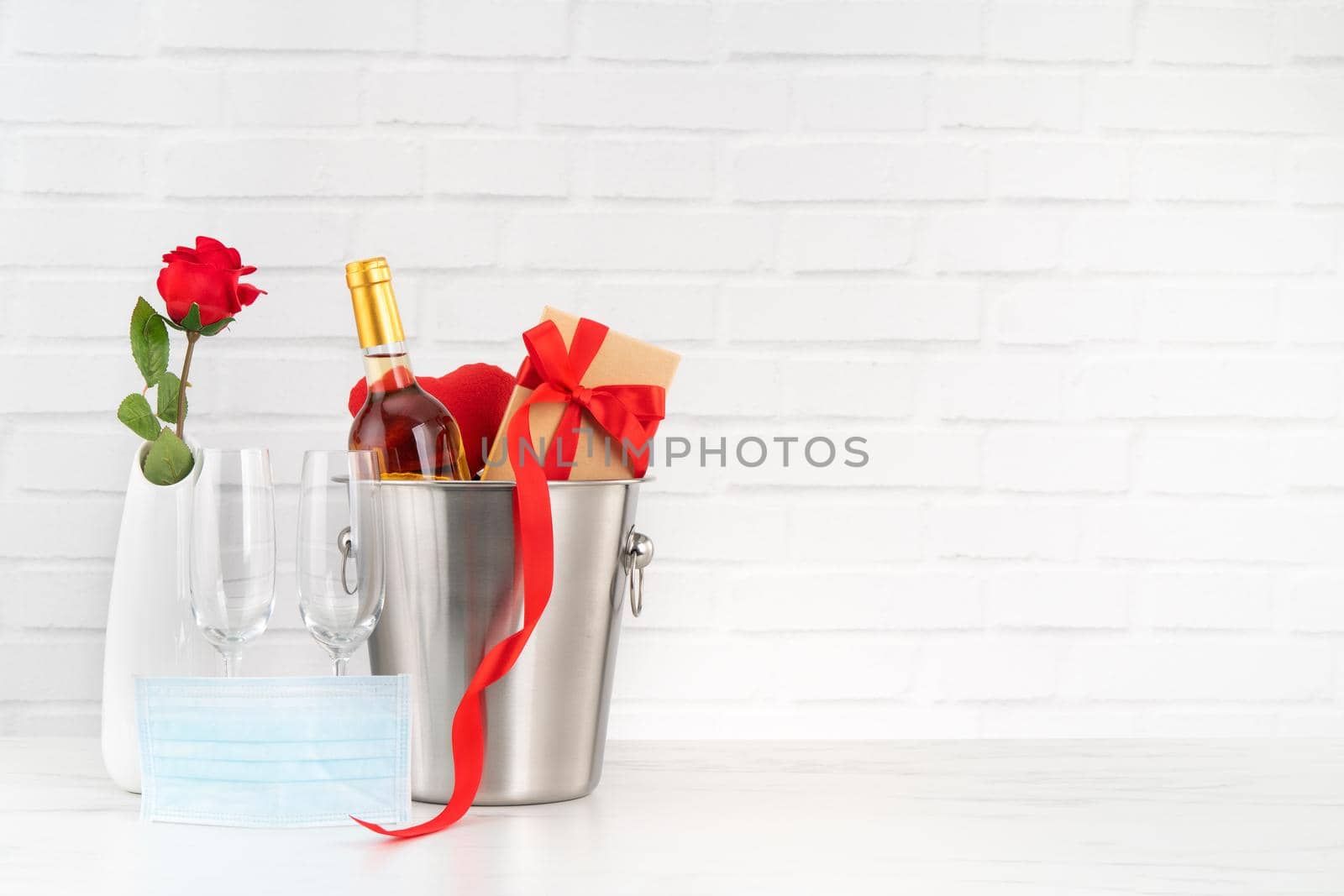 Valentine's Day celebration with wine, bouquet and face mask protection concept during this hard time.