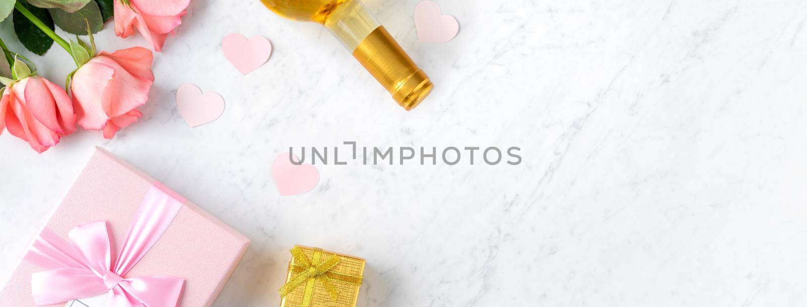 Giftbox and pink rose flower on marble white table background for Valentine's Day holiday gift design concept.