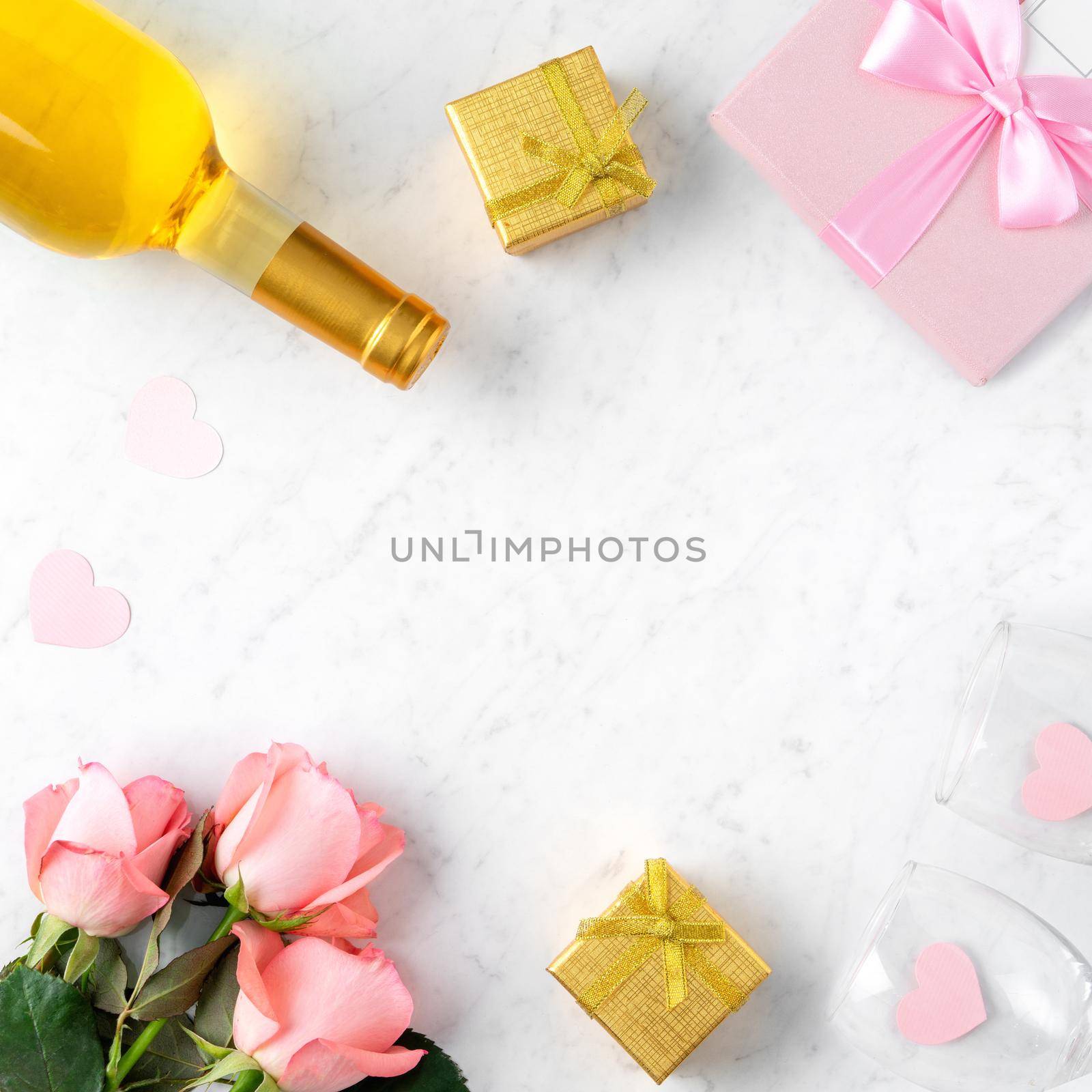 Giftbox and pink rose flower on marble white table background for Valentine's Day holiday gift design concept.