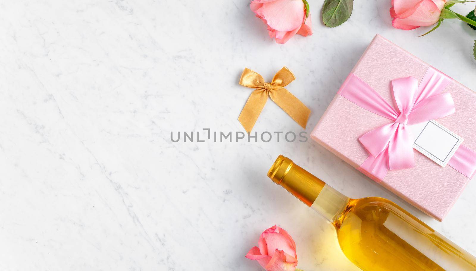 Giftbox and pink rose flower on marble white table background for Valentine's Day holiday gift design concept.