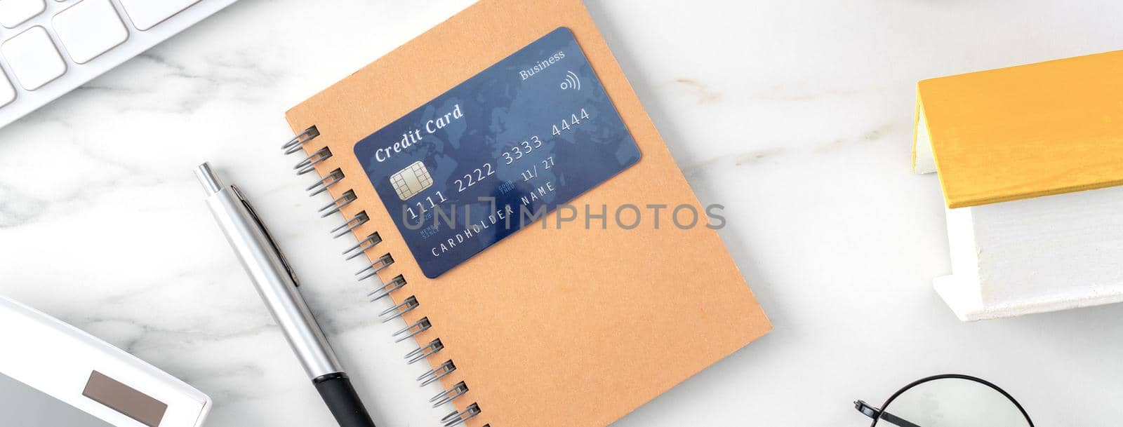 Top view of estimating and paying house tax with calculator and credit card from internet.