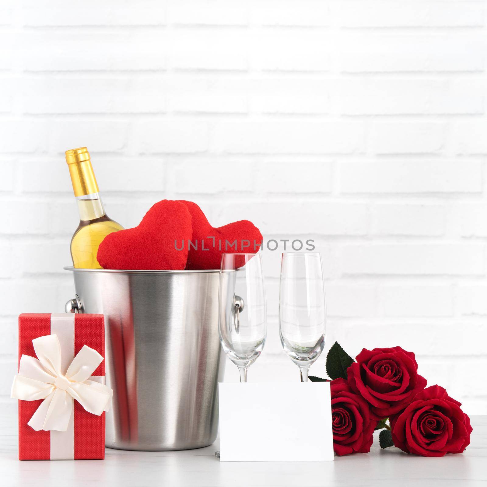 Valentine's Day celebration with wine, gift and rose bouquet for holiday greeting.