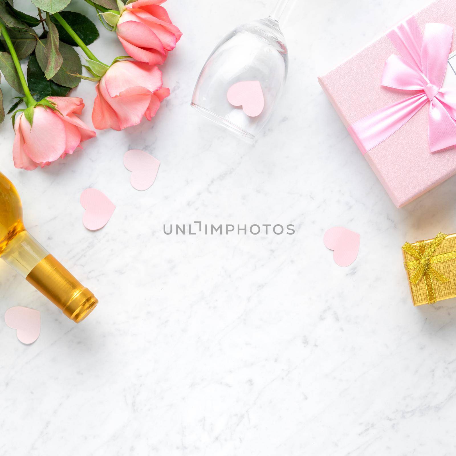 Giftbox and pink rose flower on marble white table background for Valentine's Day holiday gift design concept.