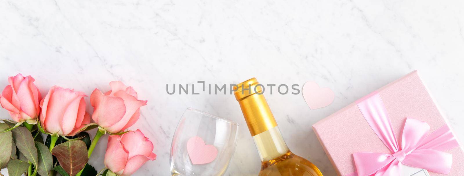 Giftbox and pink rose flower on marble white table background for Valentine's Day holiday gift design concept.