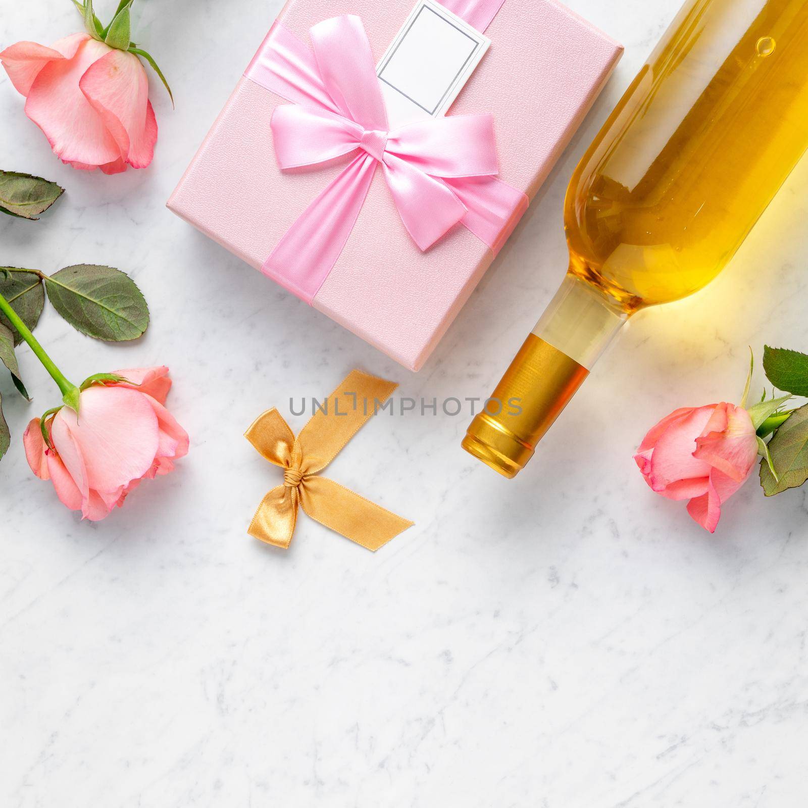 Giftbox and pink rose flower on marble white table background for Valentine's Day holiday gift design concept.