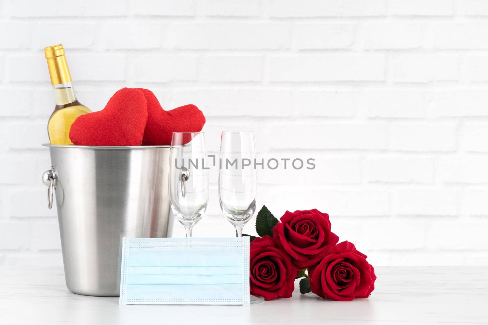 Valentine's Day celebration with wine, bouquet and face mask protection concept during this hard time.