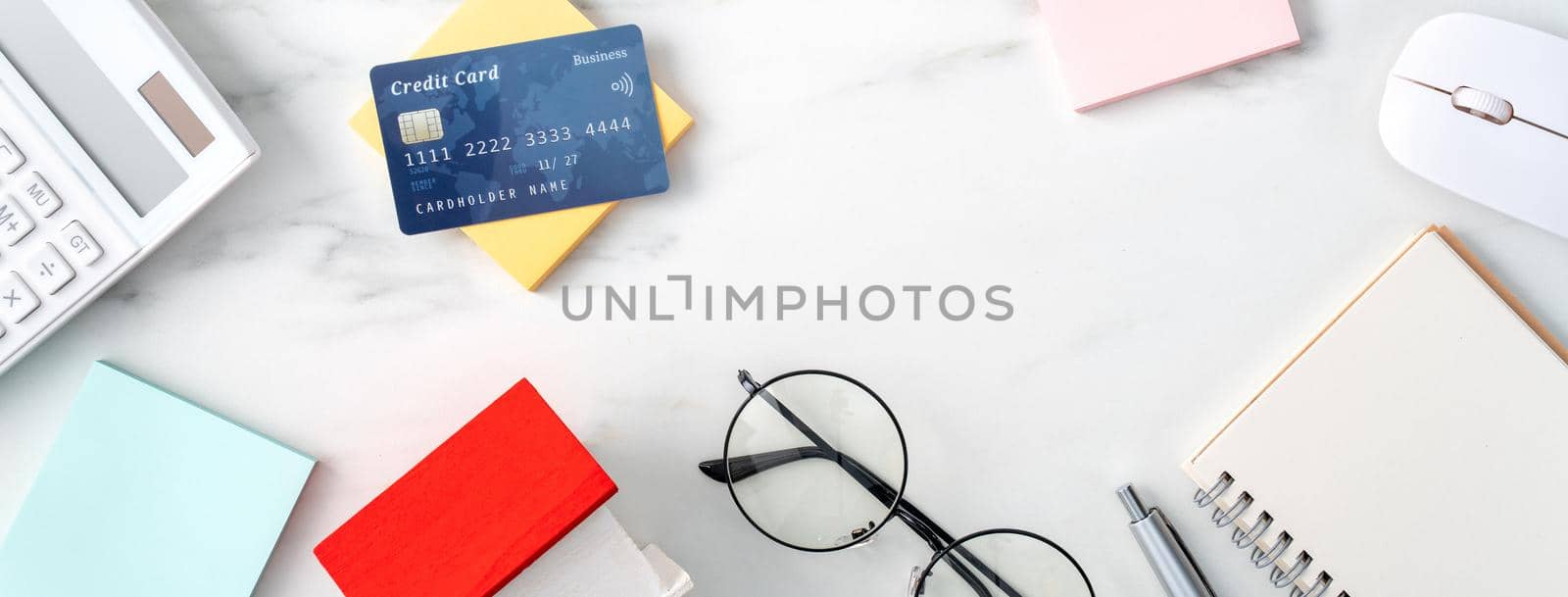 Top view of estimating and paying house tax with calculator and credit card from internet.