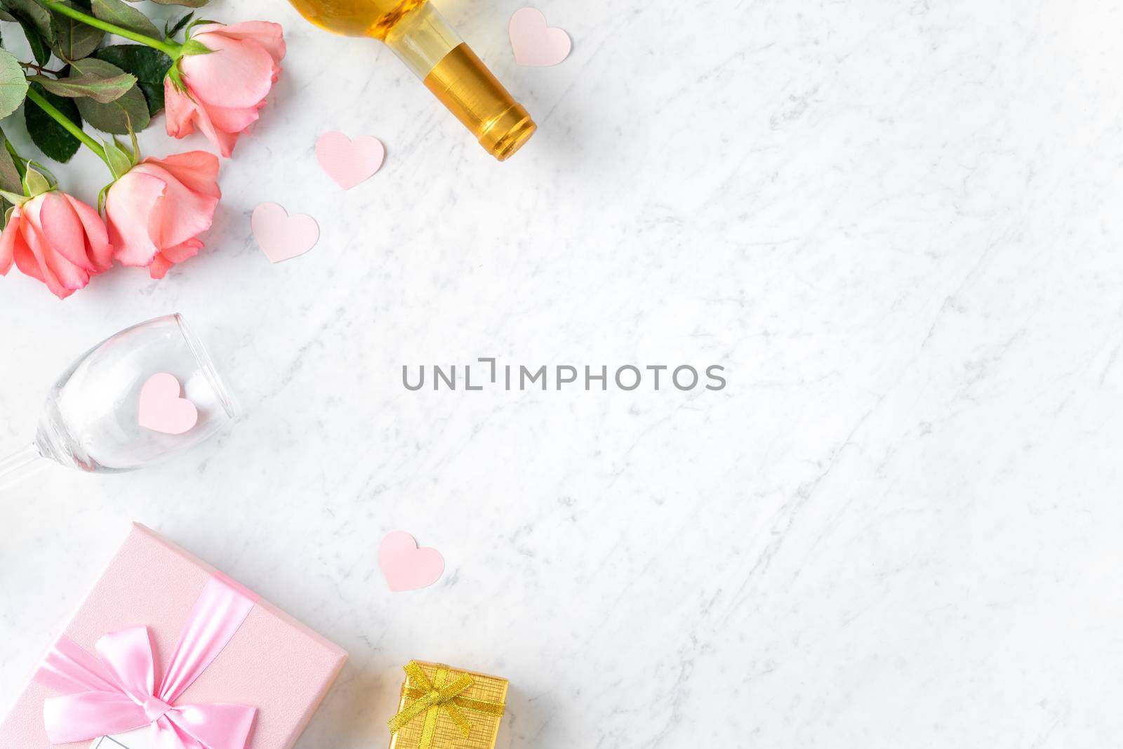 Giftbox and pink rose flower on marble white table background for Valentine's Day holiday gift design concept concept.