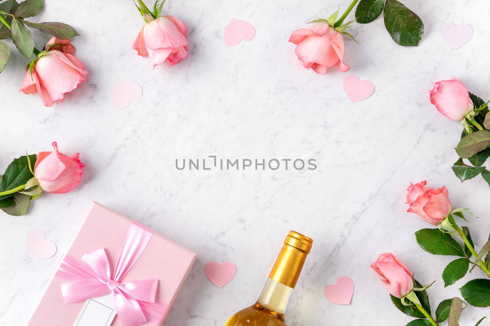 Giftbox and pink rose flower on marble white table background for Valentine's Day holiday gift design concept concept.