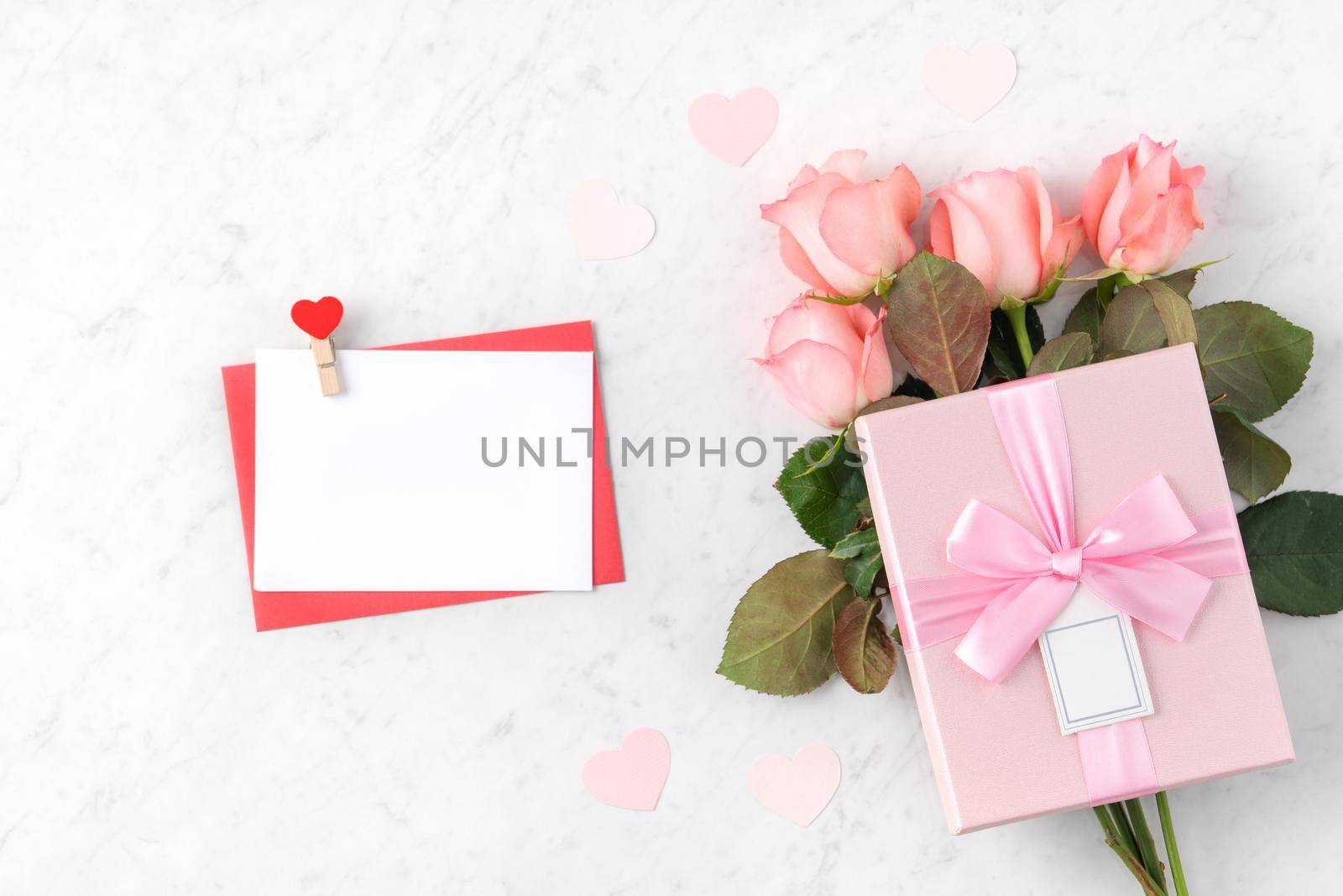 Valentine's Day design concept background with pink rose flower and gift box on marble white background
