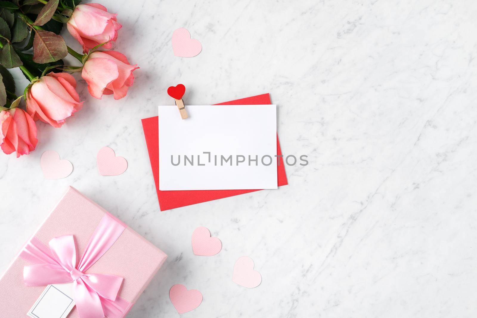 Valentine's Day design concept background with pink rose flower and gift box on marble white background