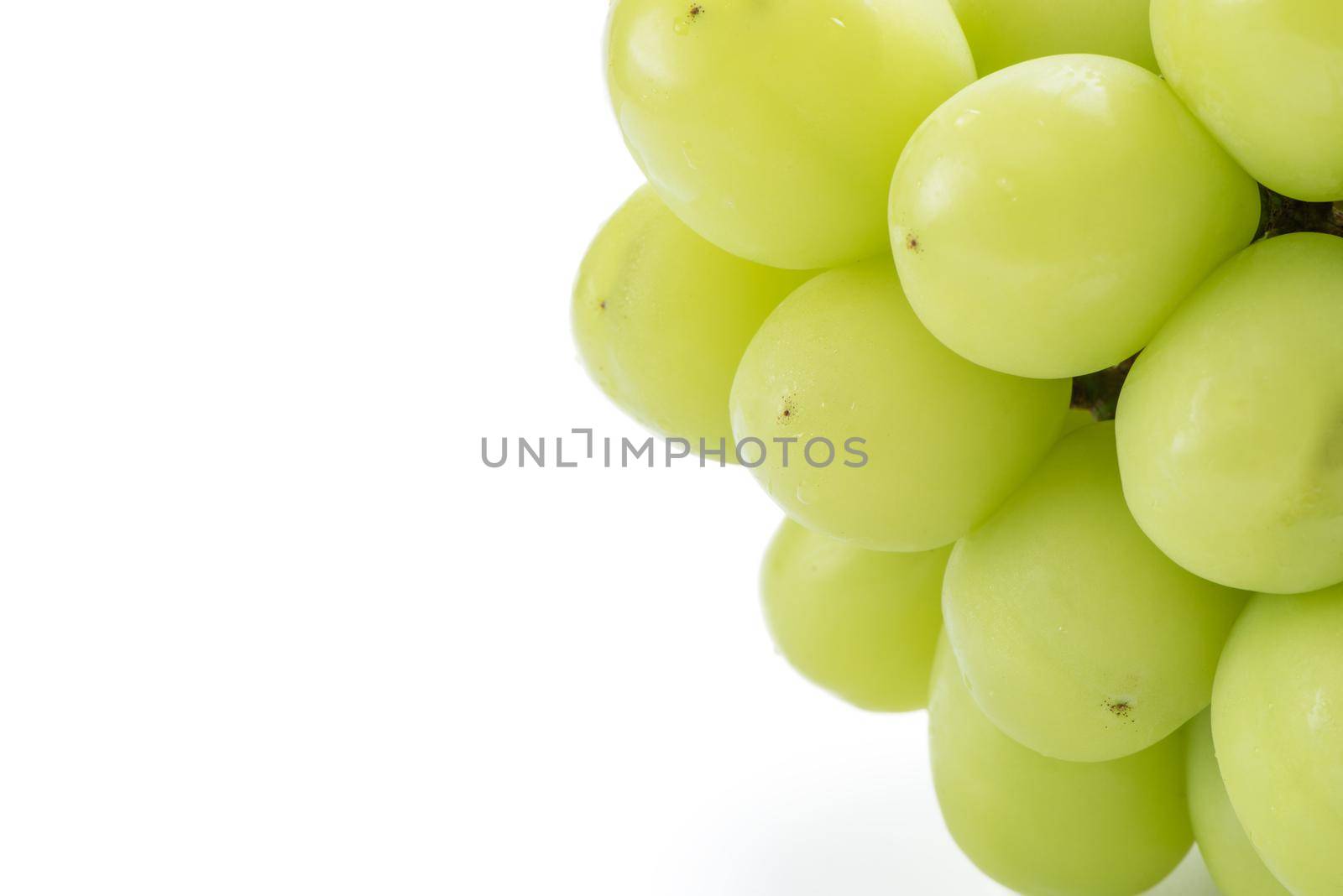 Close up of beautiful a bunch of Shine Muscat green grape isolated on white background, clipping path cut out.