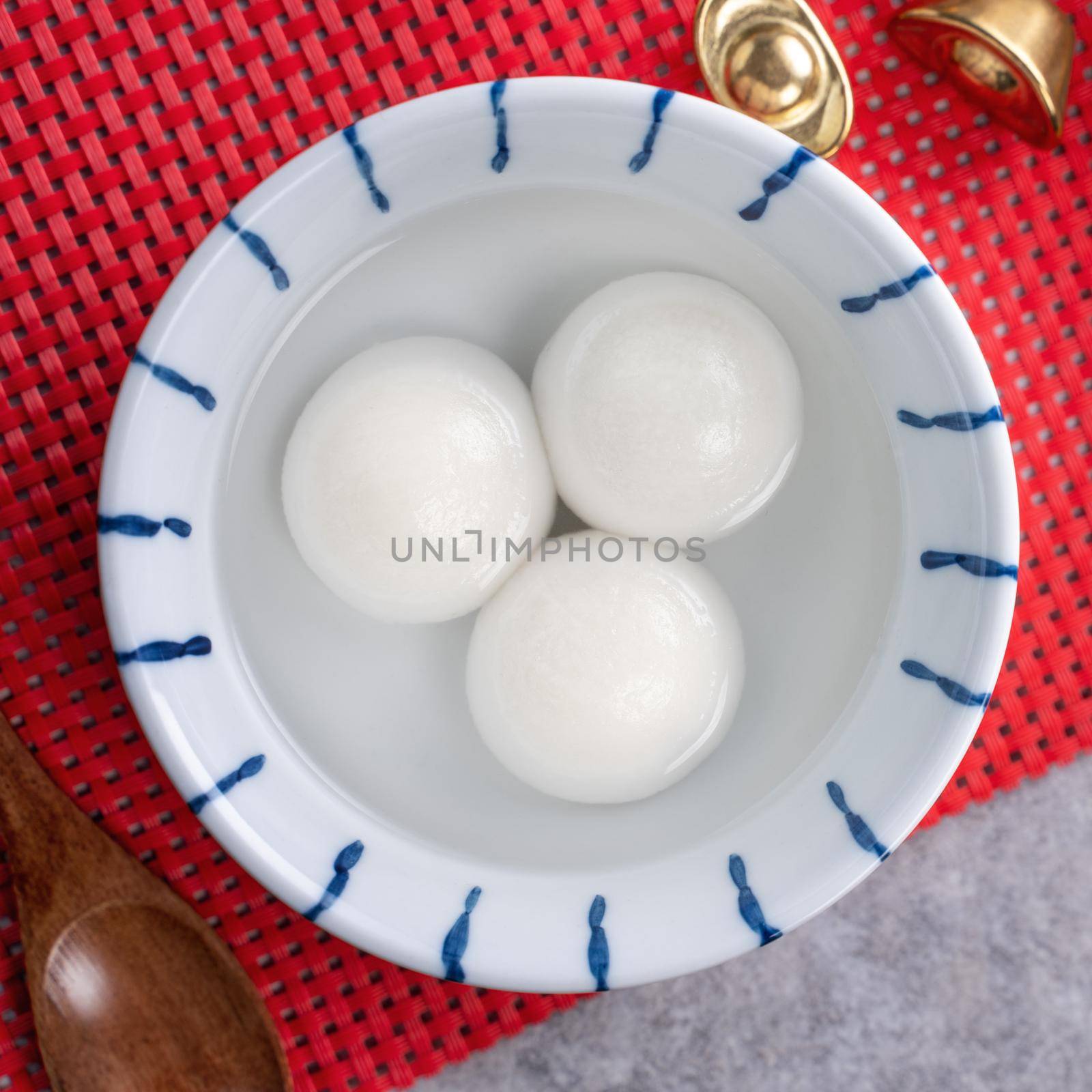 Top view of big tangyuan yuanxiao (glutinous rice dumpling balls) for Chinese lunar new year festival food, words on the golden coin means the Dynasty name it made.