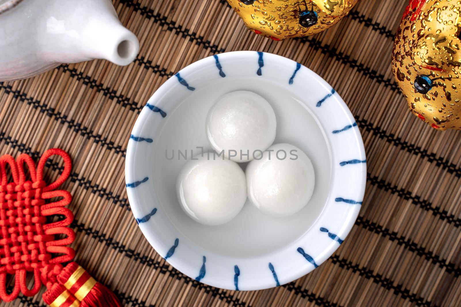 Top view of big tangyuan yuanxiao (glutinous rice dumpling balls) for Chinese lunar new year festival food, words on the golden coin means the Dynasty name it made.