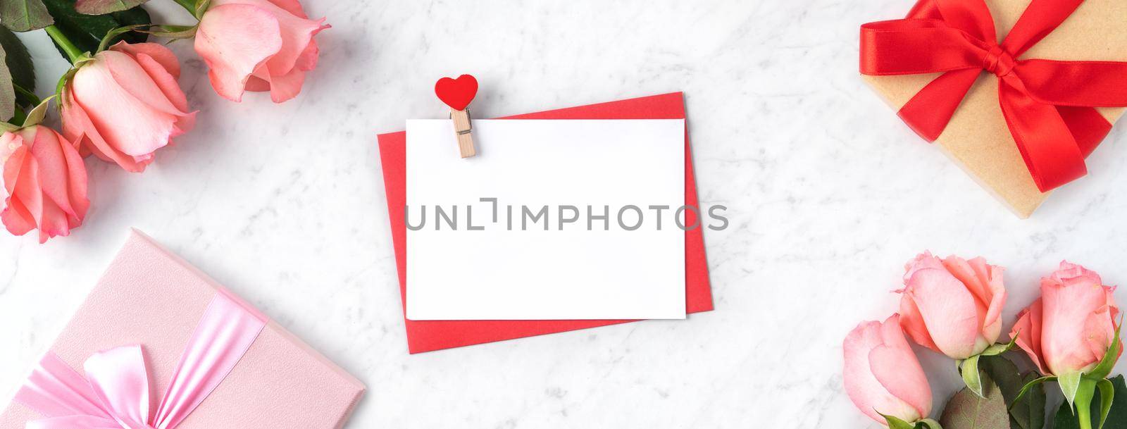 Valentine's Day design concept background with pink rose flower and gift box on marble white background