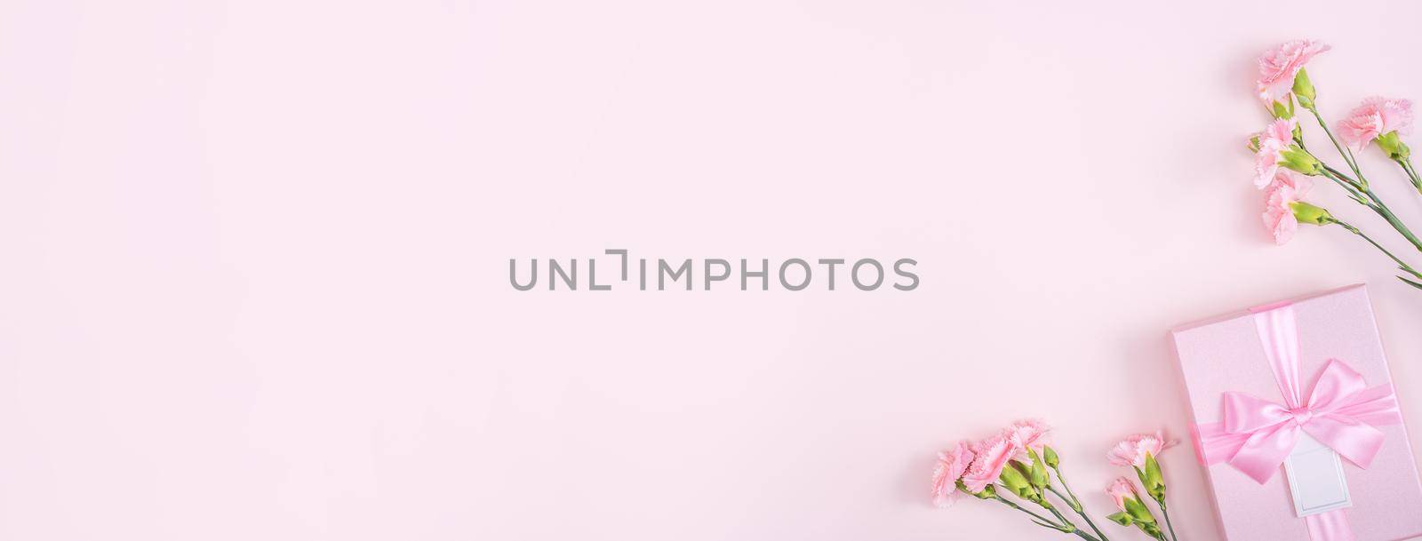 Mother's Day, Valentine's Day background design concept, beautiful pink carnation flower bouquet on pastel pink table, top view, flat lay, copy space.