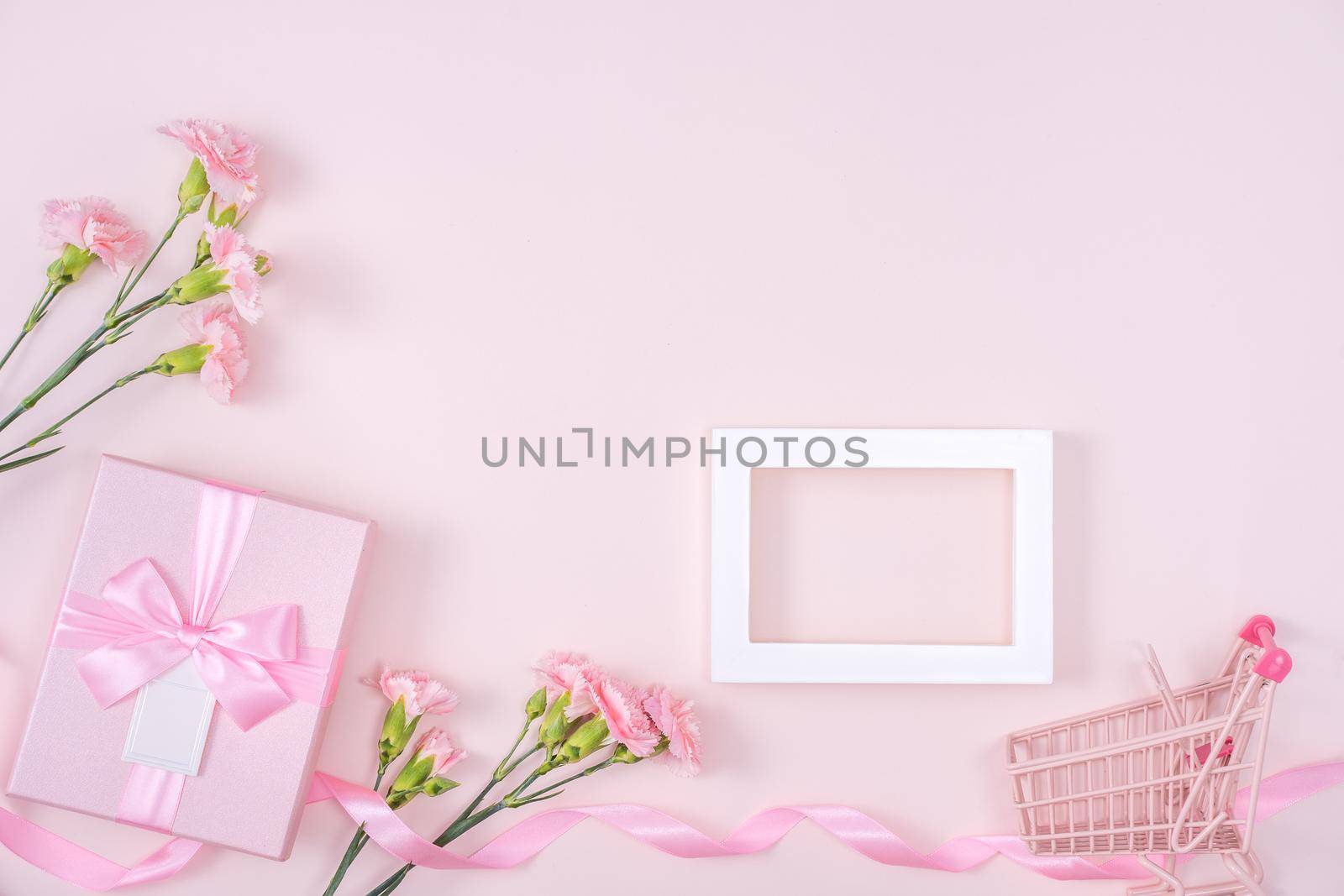 Mother's Day, Valentine's Day background design concept, beautiful pink carnation flower bouquet on pastel pink table, top view, flat lay, copy space.