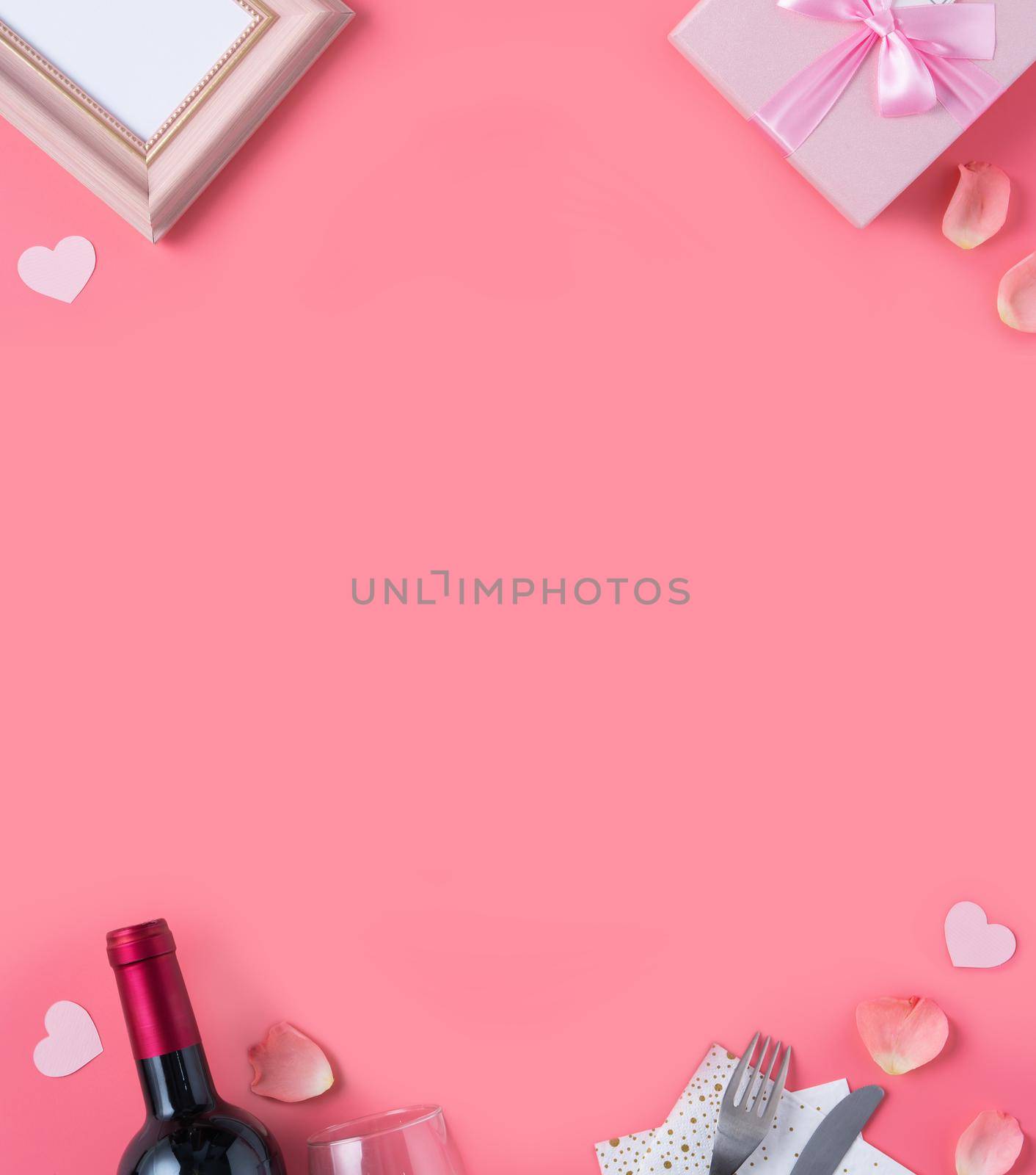 Valentine's Day design concept background with pink petals and gift box on pink background