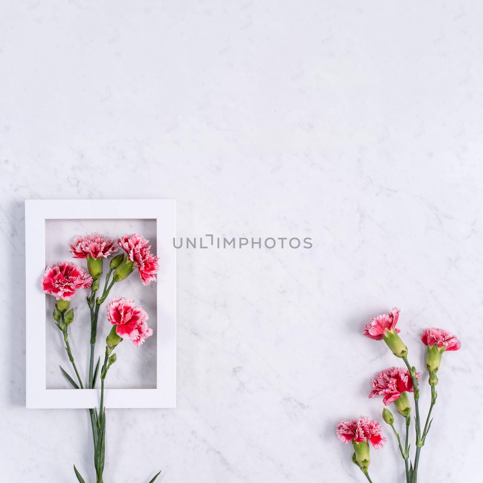 Top view of Mother's Day background design concept with carnation flower bouquet on marble table