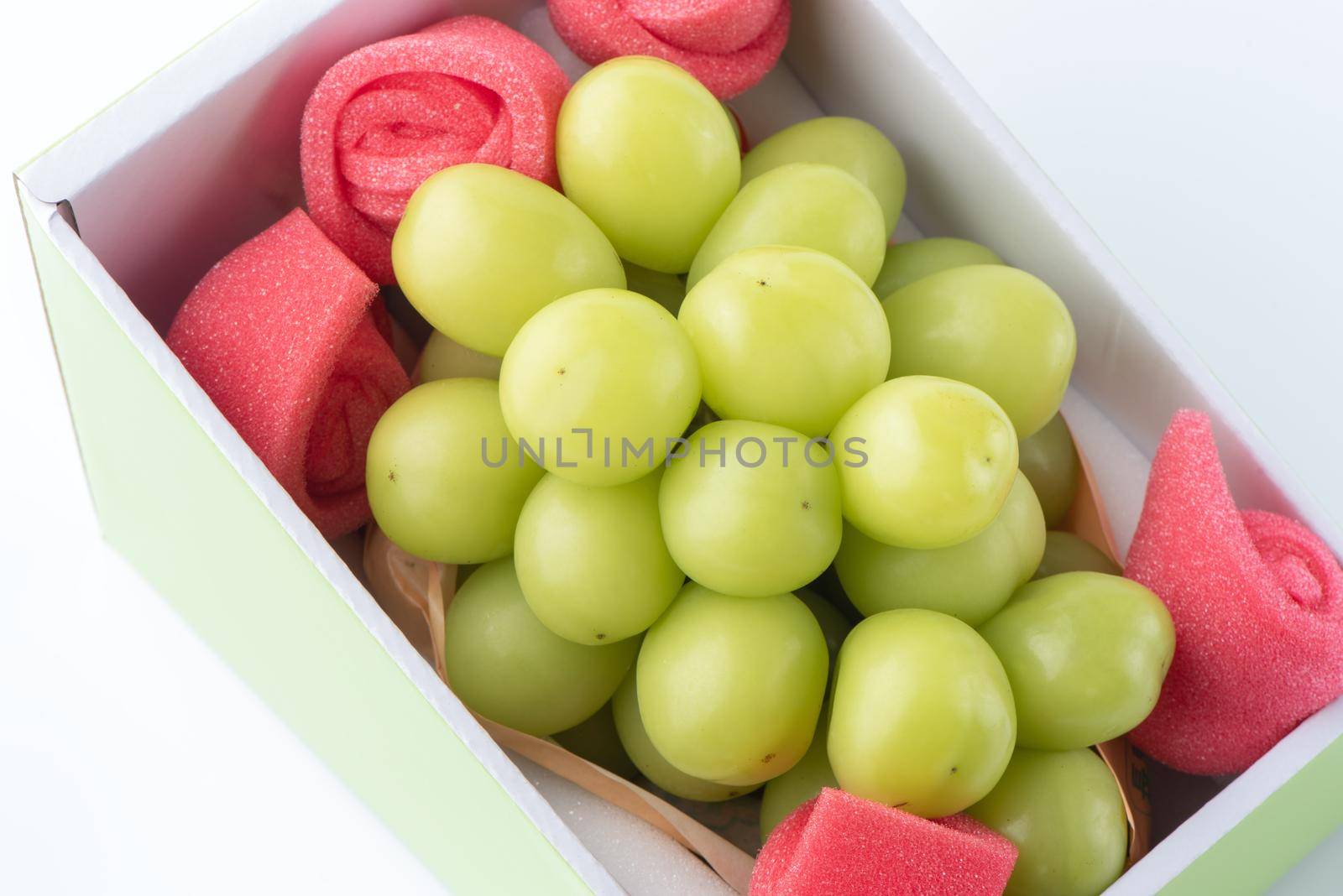 Close up of beautiful boxed Shrine Muscat green grape isolated on white background, clipping path cut out.