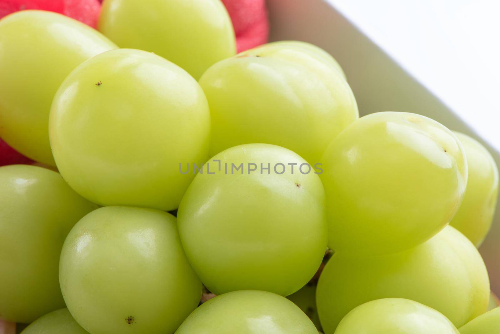 Close up of beautiful boxed Shrine Muscat green grape isolated on white background, clipping path cut out.