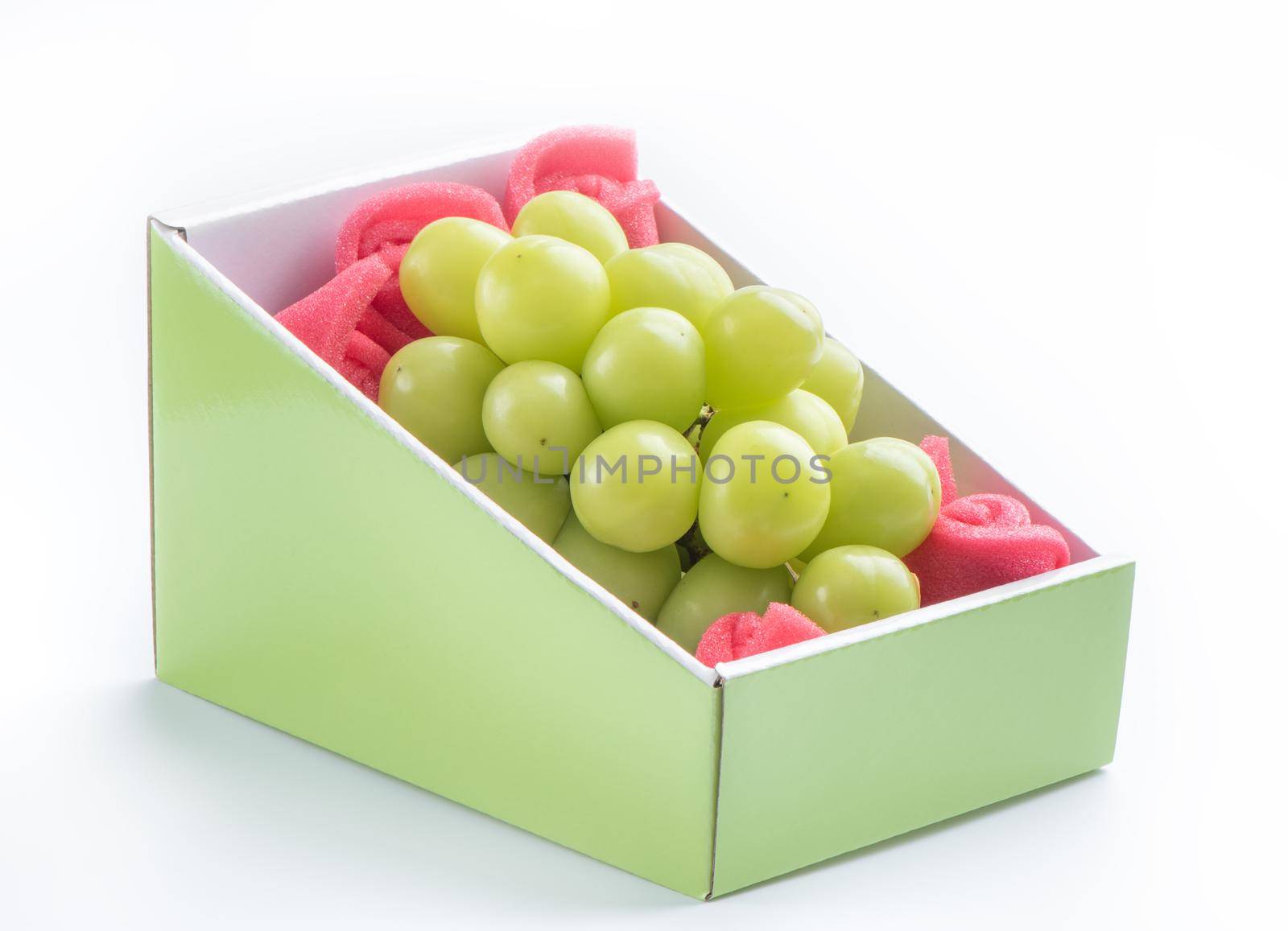 Close up of beautiful boxed Shrine Muscat green grape isolated on white background, clipping path cut out.