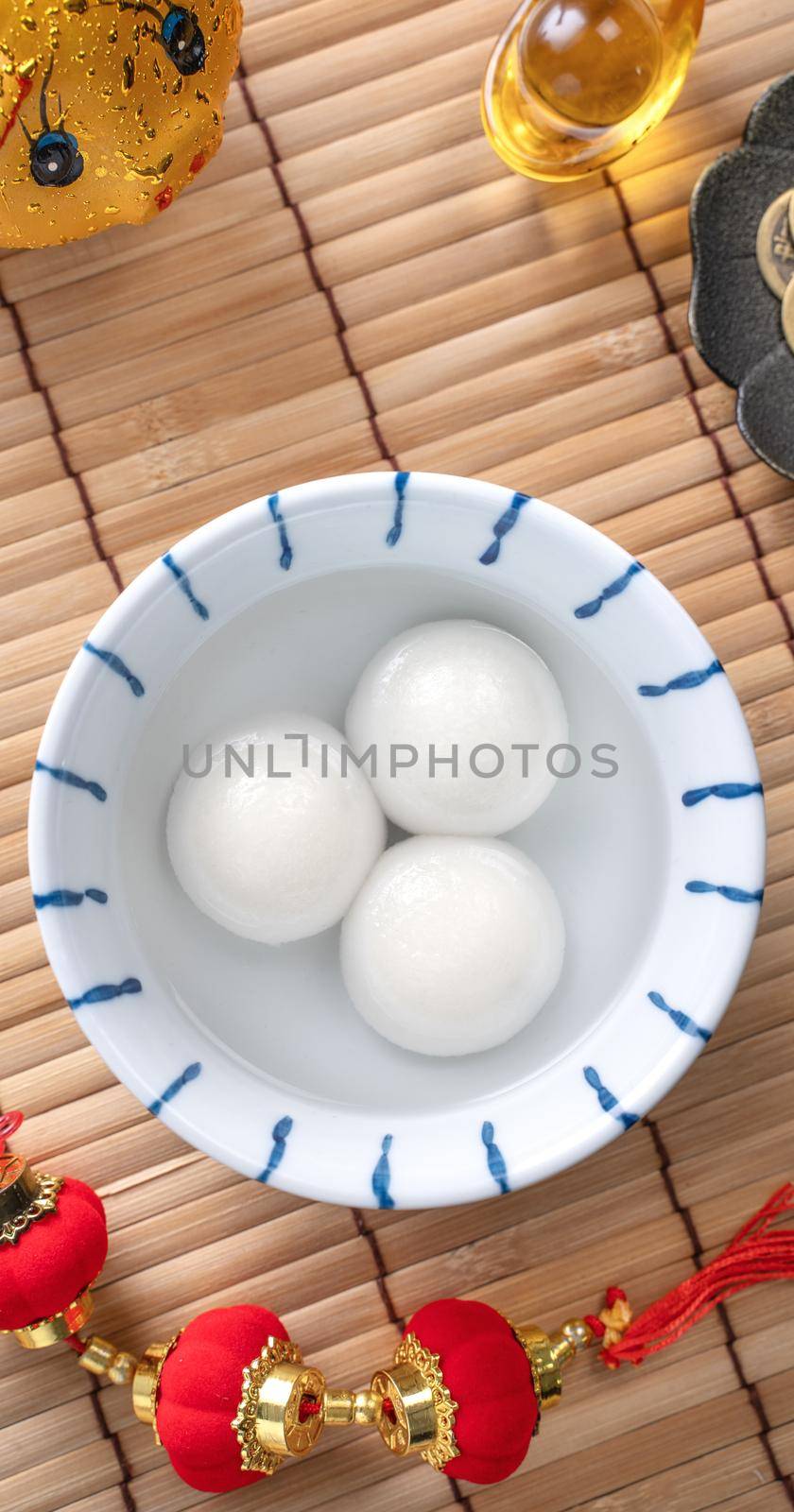Top view of big tangyuan yuanxiao (glutinous rice dumpling balls) for Chinese lunar new year festival food, words on the golden coin means the Dynasty name it made.