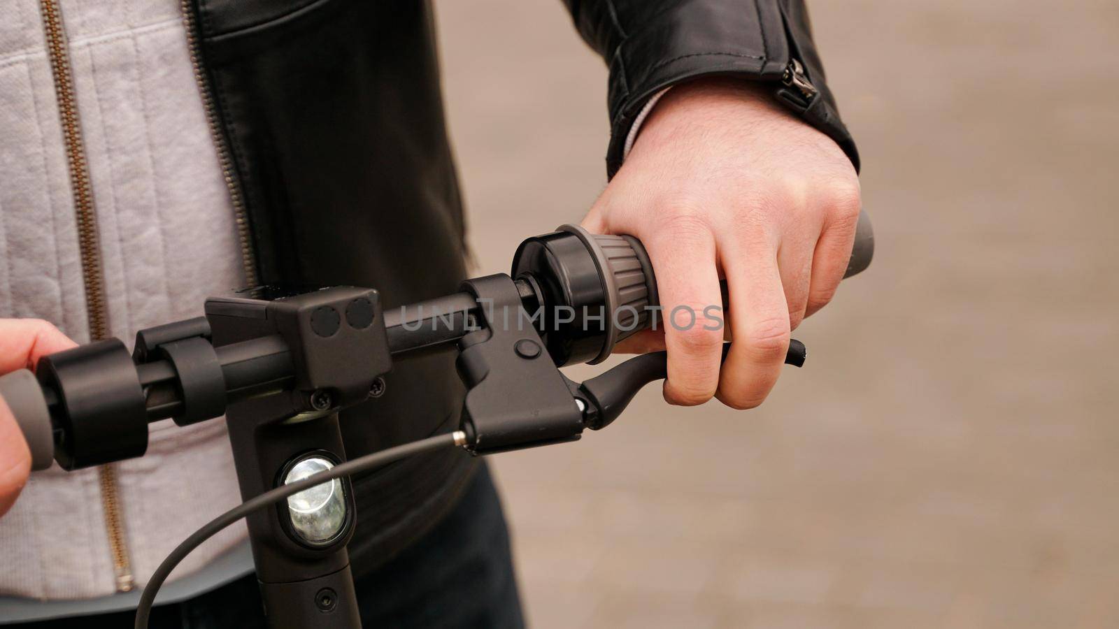 Electric scooter handlebar and man hand on the lever by natali_brill