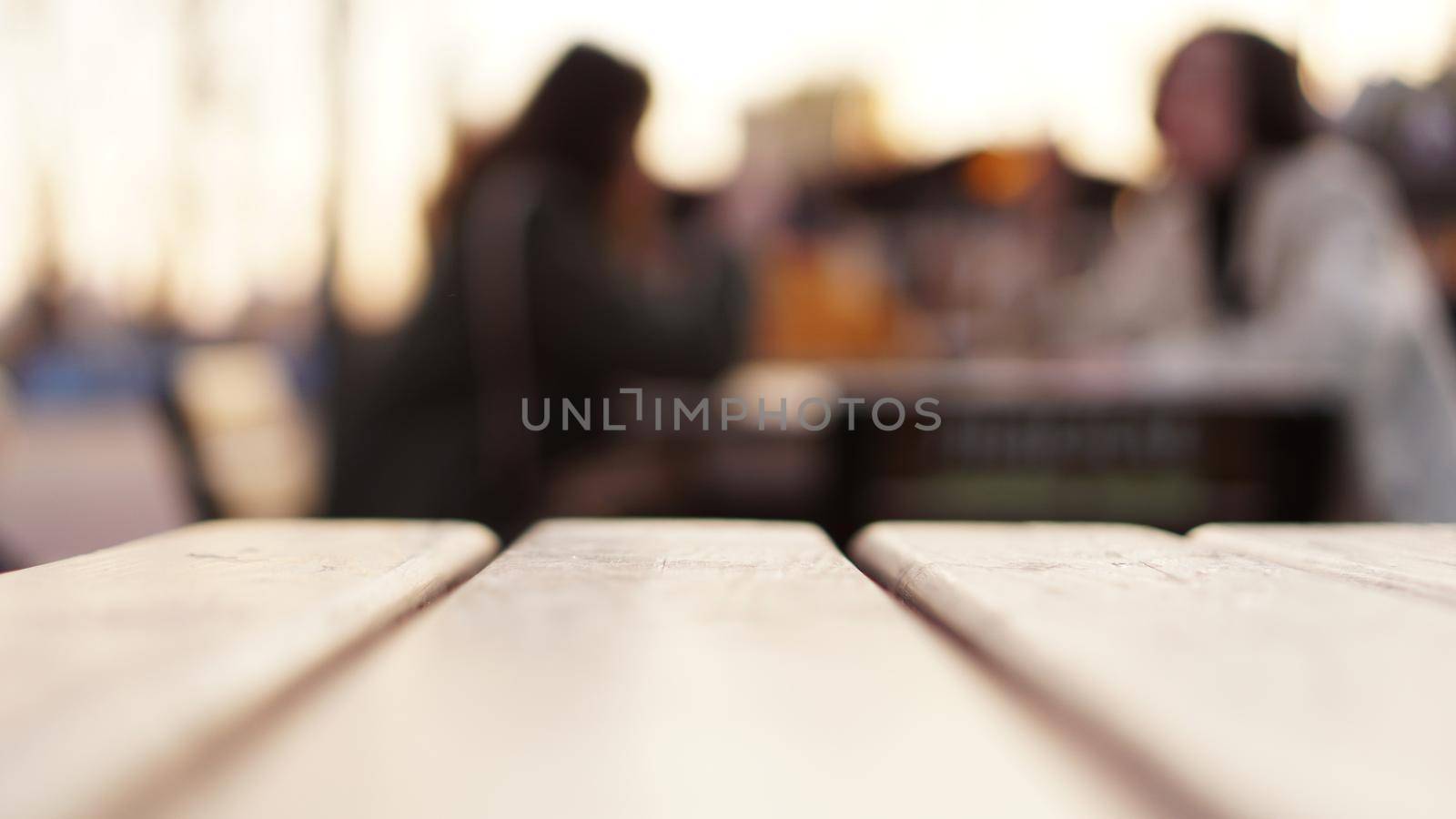 Blurred abstract background with street food court. Food court table and visitors. Blur Urban life scene.