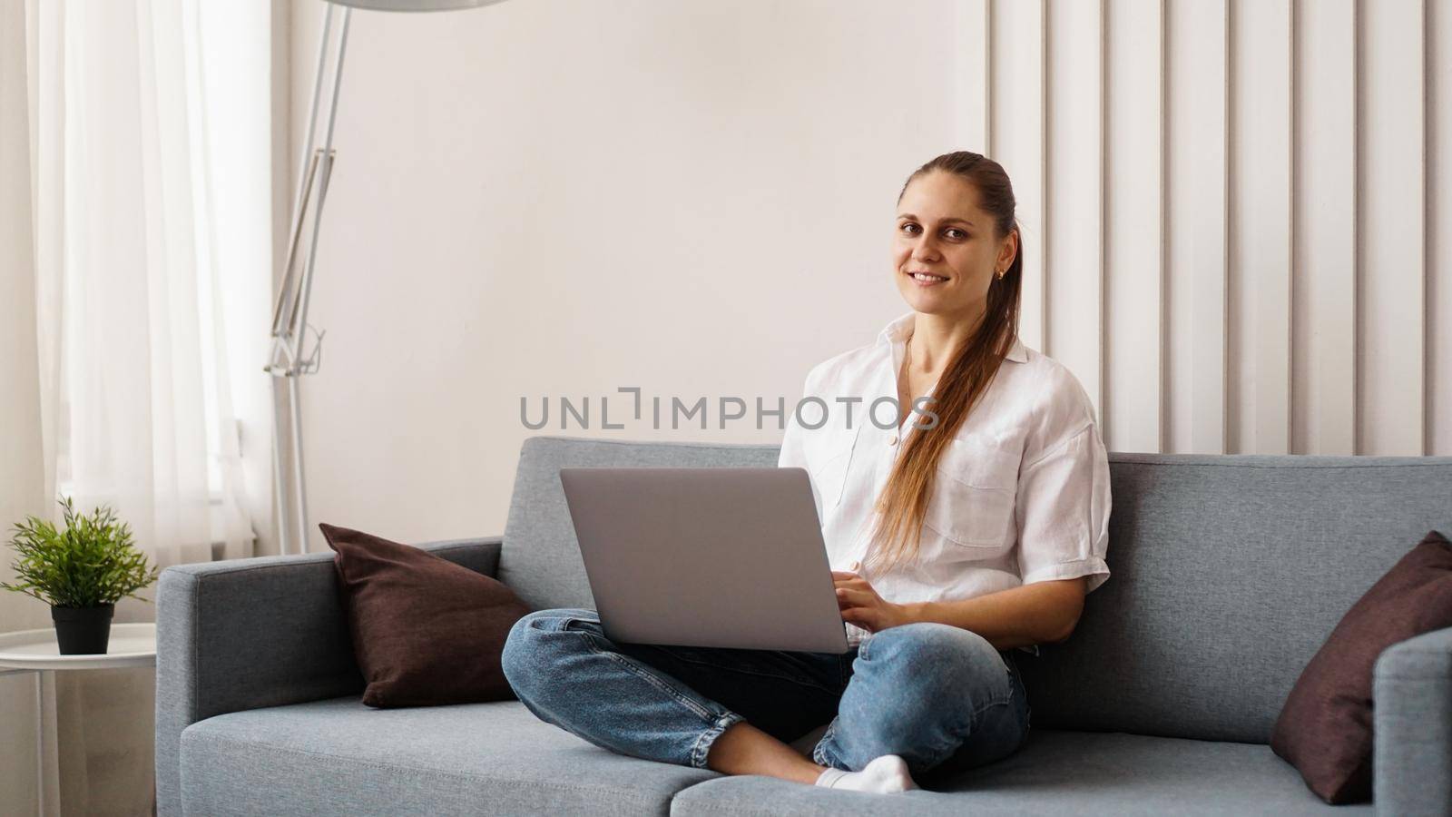 Woman working on laptop from home or student studying from home or freelancer by natali_brill
