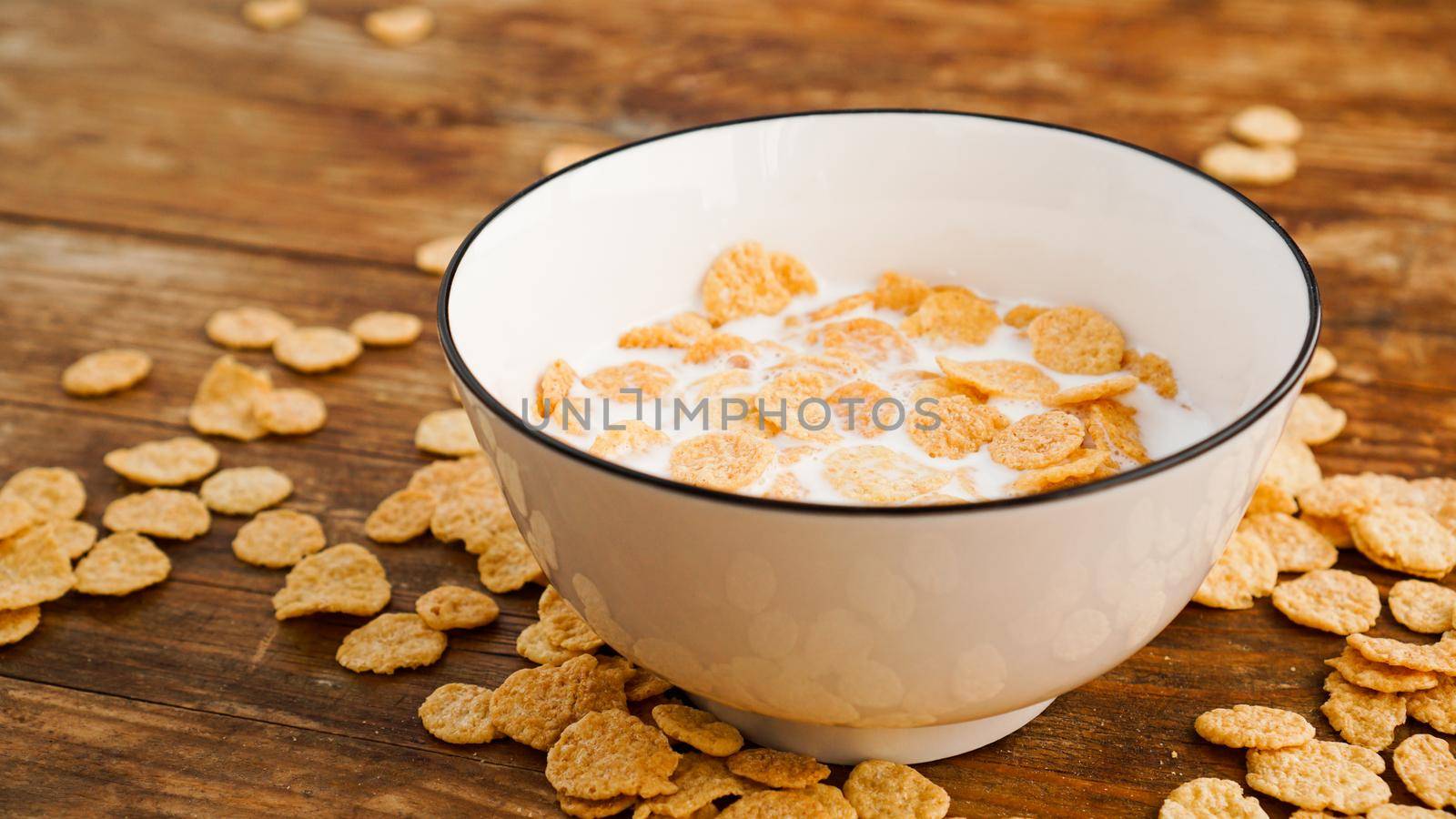 Eco healthy food background. Corn flakes with milk. Flakes in milk in a white bowl. Healthy food and fresh breakfast