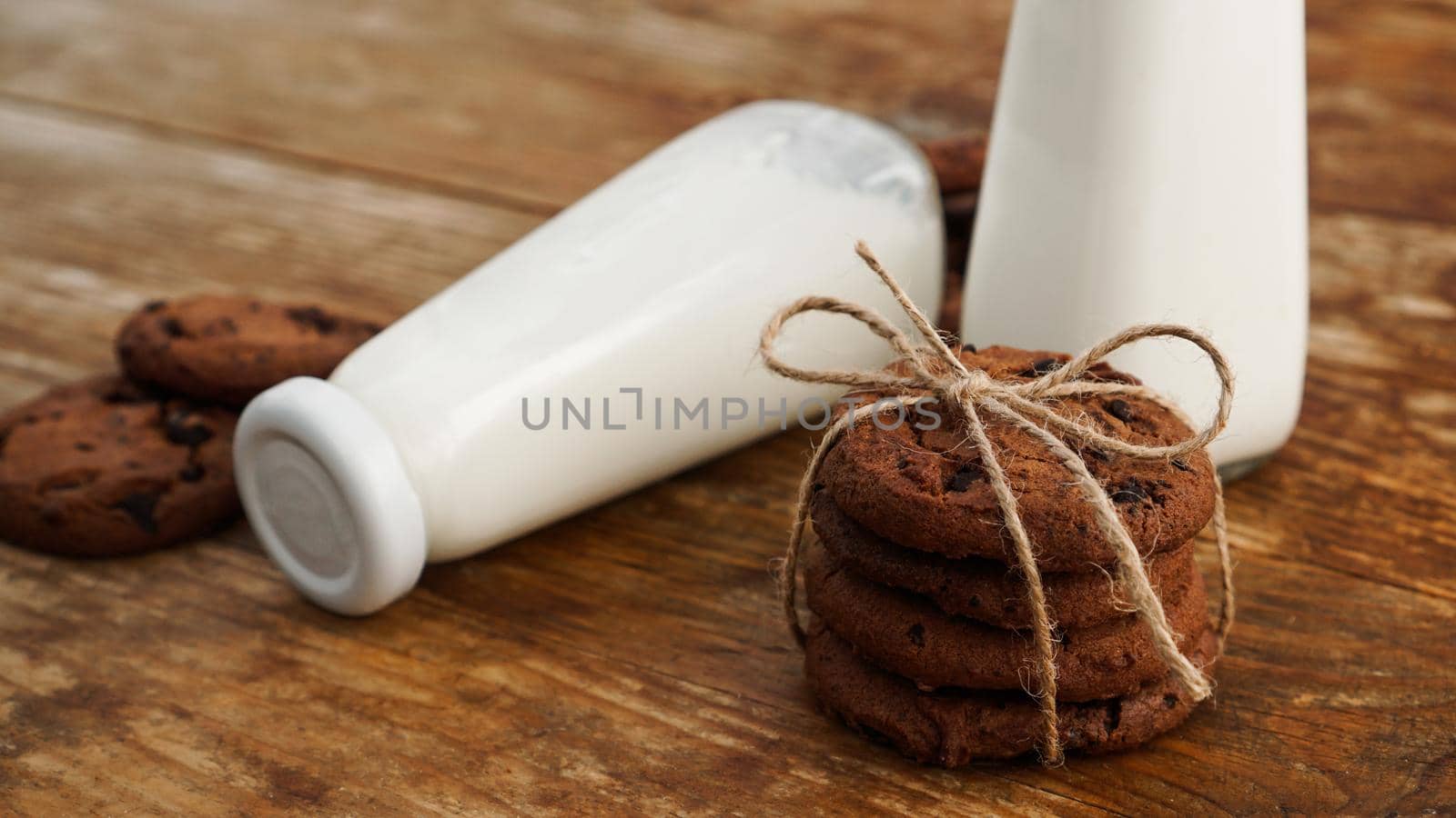 Chocolate cookie with milk on wooden table. Homemade cookies. The concept of natural and healthy nutrition. Bakery products