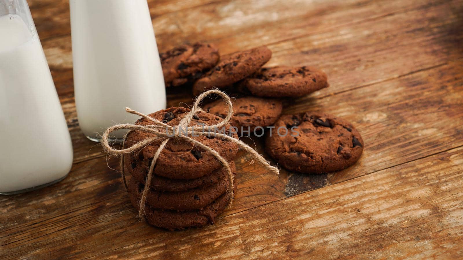 Chocolate cookie with milk on wooden table. Homemade cookies. The concept of natural and healthy nutrition. Bakery products