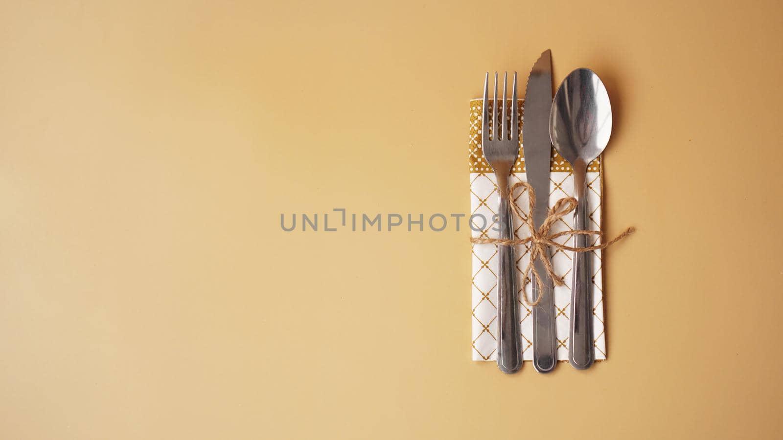 Festive table setting on simple gold background. Beautiful flat lay arrangement.