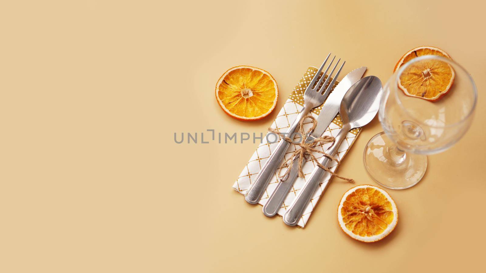Setting of table with dry orange on gold background