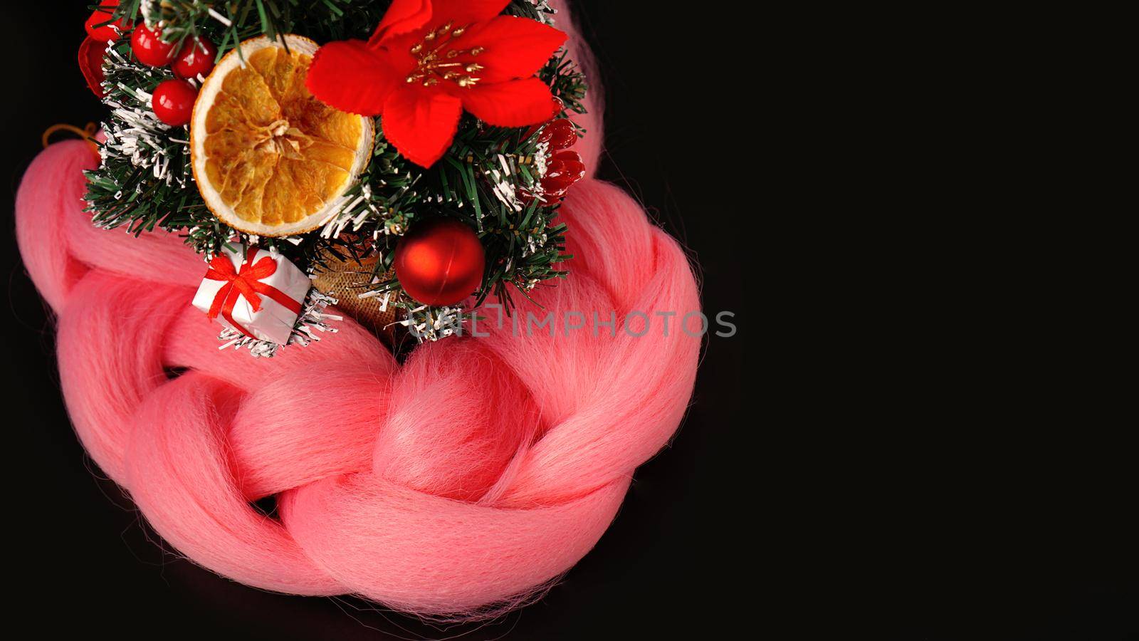 Synthetic pink kanekalon - Christmas photo with decoration on black. New Year photo for a store or hairdressing salons, barbershops