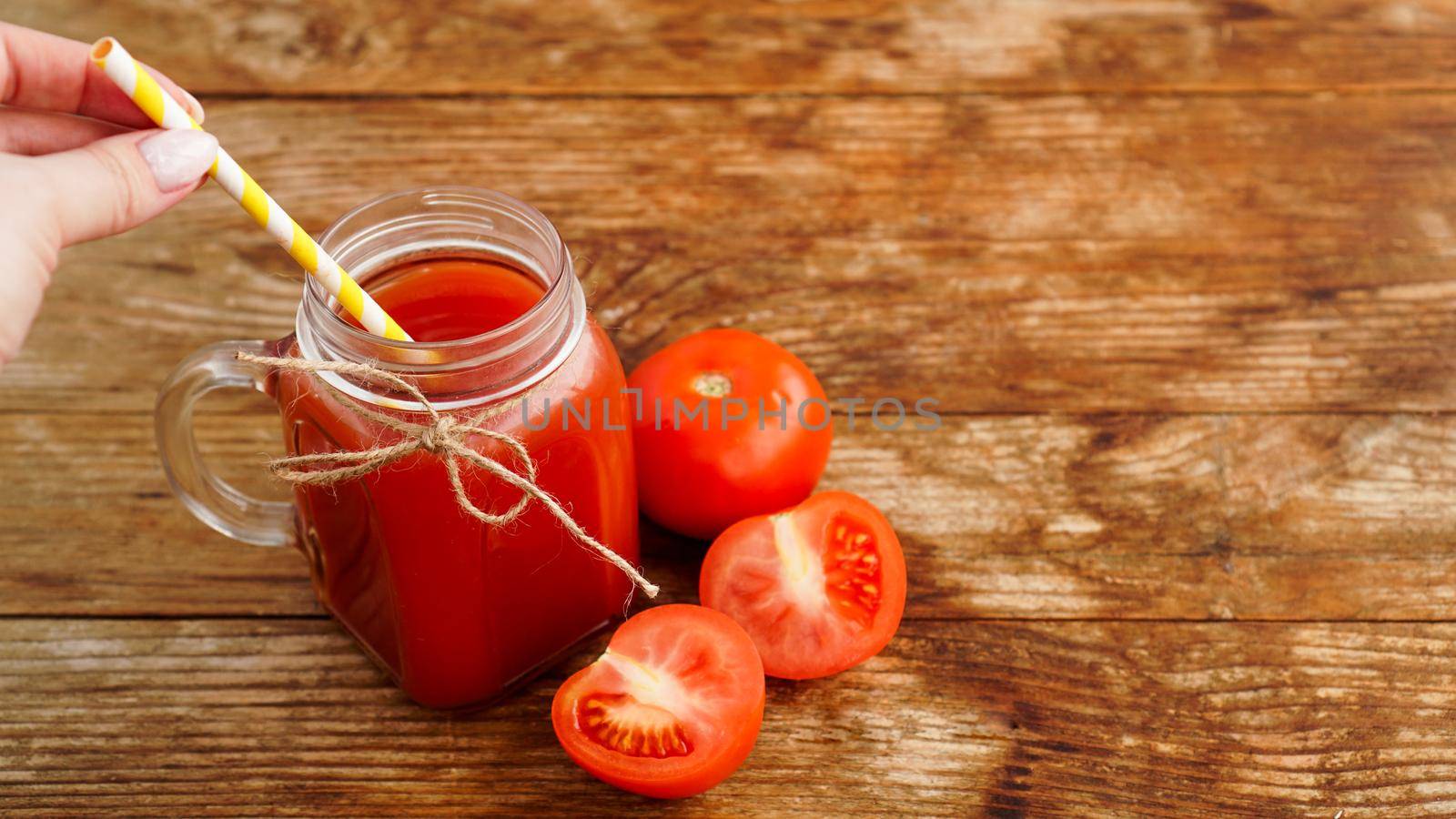 Glass of tomato juice on wooden table. Fresh tomato juice and chopped tomatoes by natali_brill