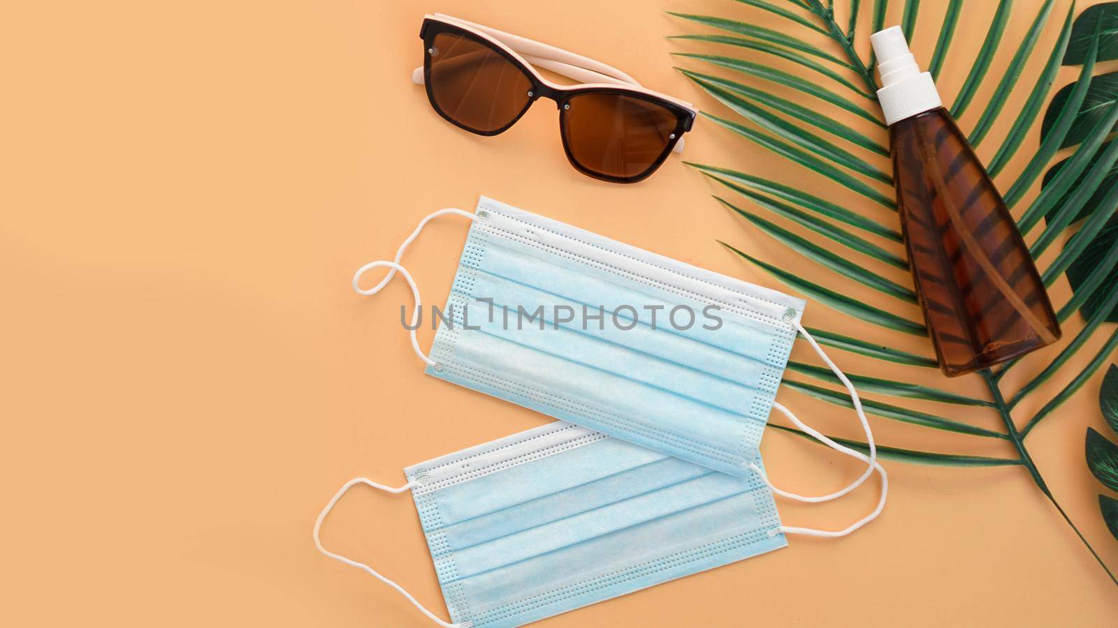 Sunglasses, protection spf cream, medical masks. Beach accessory. Summer travel in coronavirus quarantine concept