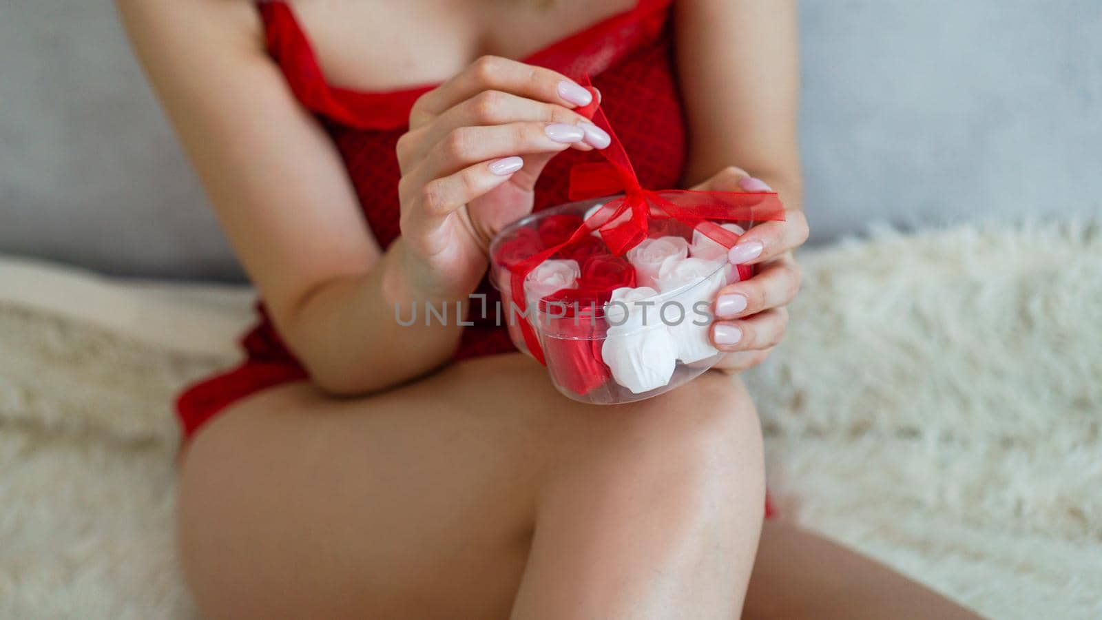 Girl opens a gift, enjoying present at home, romantic relationship. Valentine day, love and happiness concept