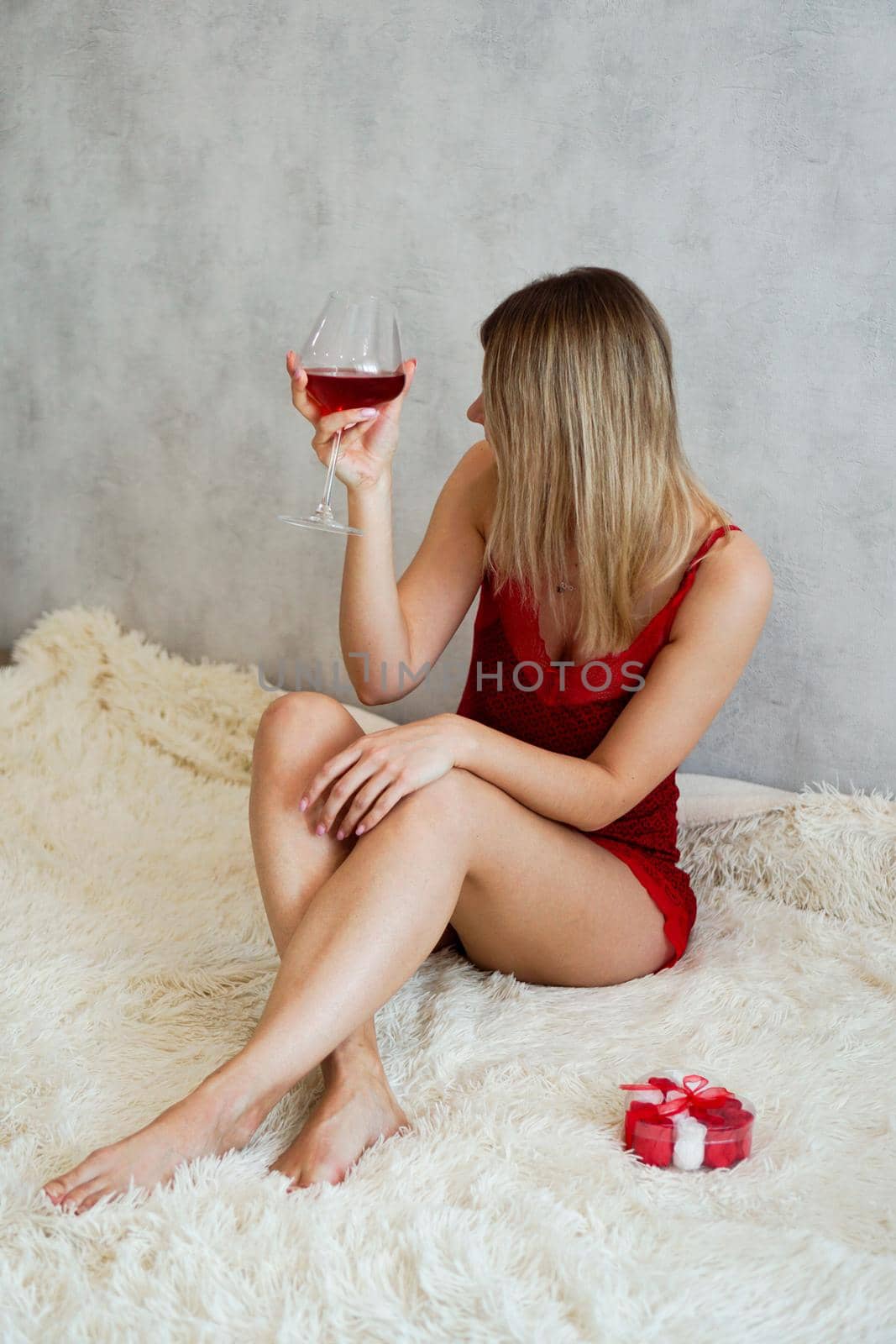 A beautiful young woman with wine in her hand. Valentines morning by natali_brill