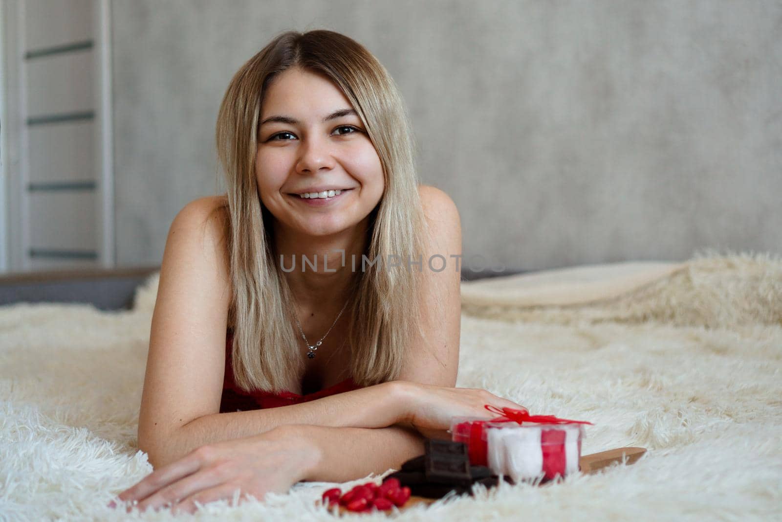 Romance, valentine day gifts concept. Beautiful blonde woman on sofa with gifts