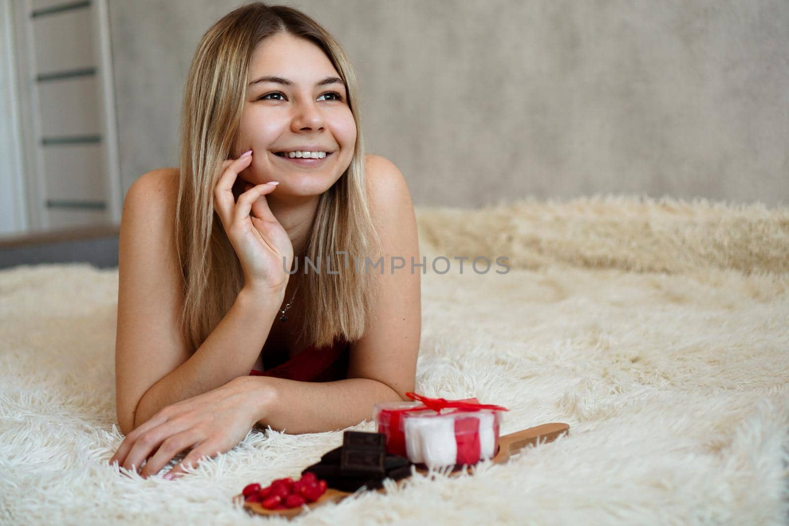 Romance, valentine day gifts concept. Beautiful blonde woman on sofa with gifts