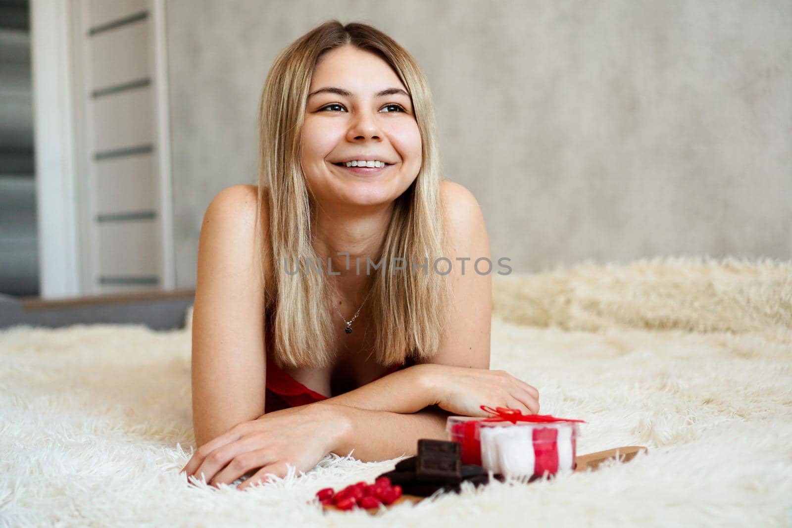 Romance, valentine day gifts concept. Beautiful blonde woman on sofa with gifts