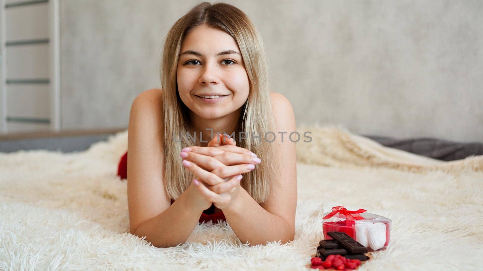 Romance, valentine day gifts concept. Beautiful blonde woman on sofa. by natali_brill