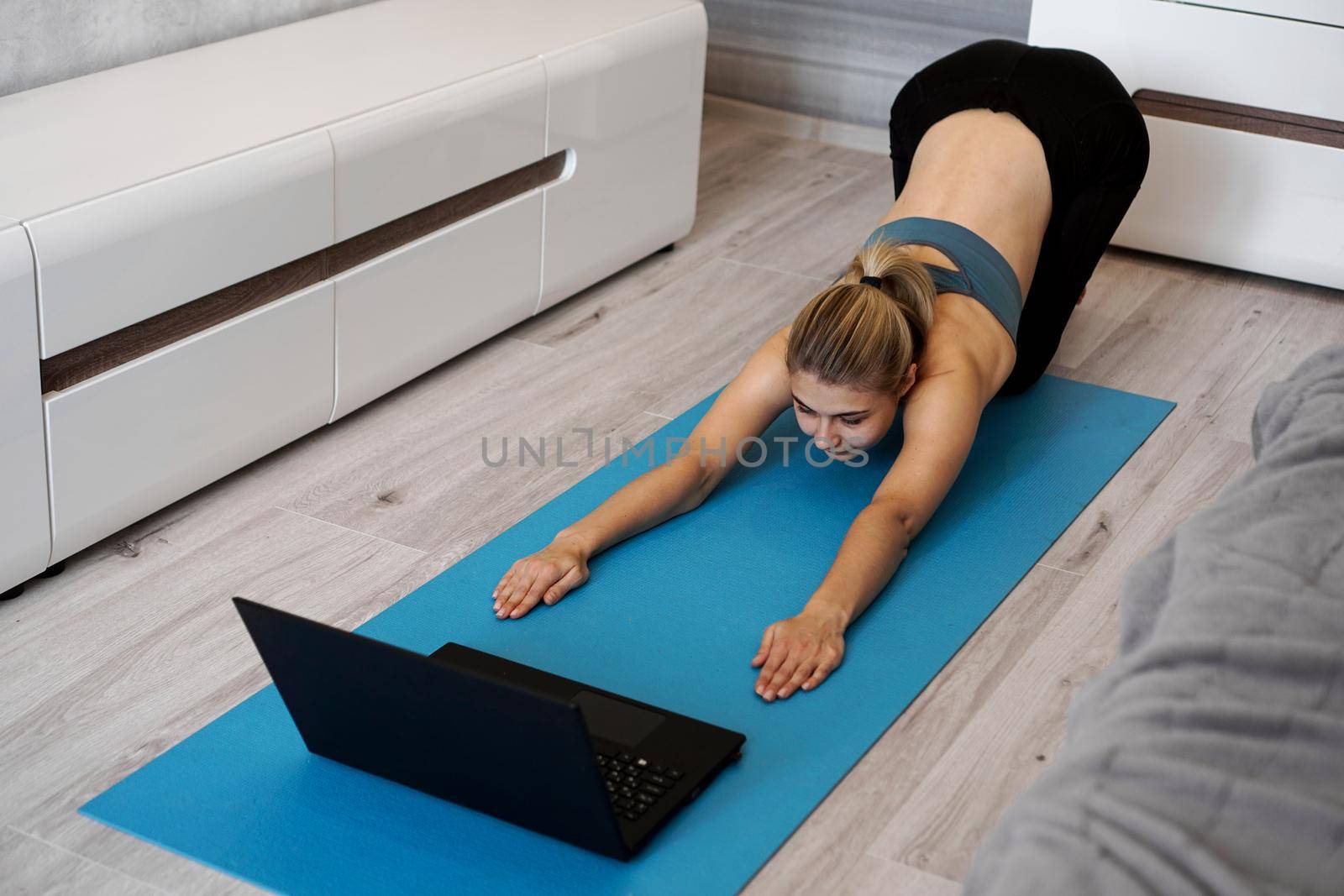 Health concept. Woman meditating or doing yoga exercise at home. by natali_brill