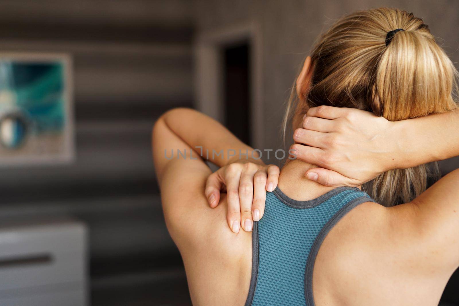 Sports injury concept. Athletic girl feeling pain in her neck by natali_brill