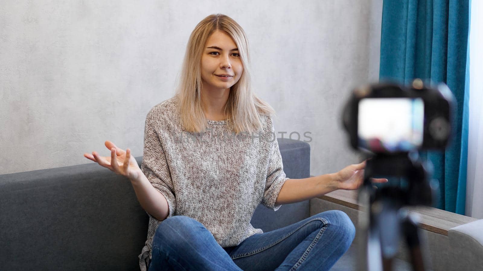 Young and smart. Beautiful young woman in casual wear while recording video blod