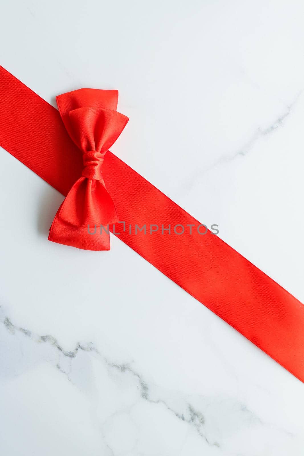 Holiday decor, feminine design and flatlay concept - Red silk ribbon on marble, top view