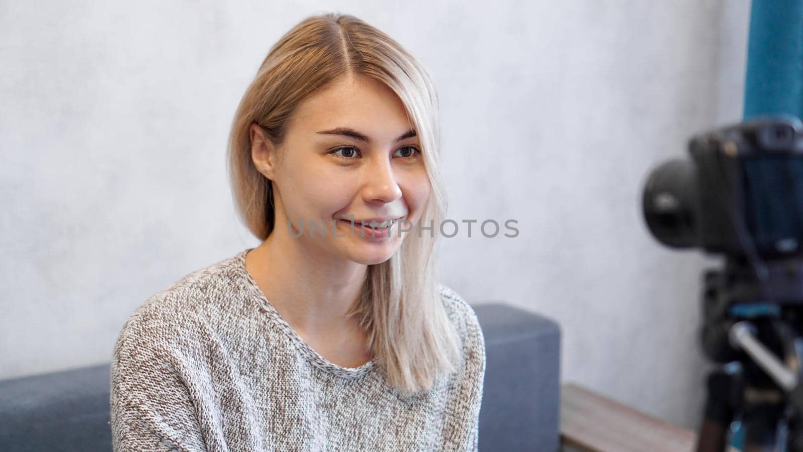 Young and smart. Beautiful young woman in casual wear while recording video blod